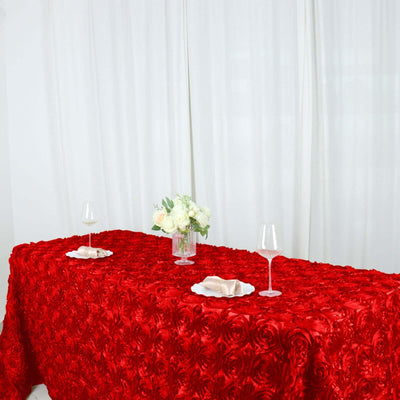 Elegant red rose tablecloth with white floral centerpiece and wine glasses.