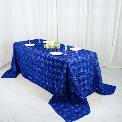 Blue rose-patterned tablecloth draped over a dining table setting.