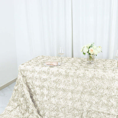 Elegant rose-patterned tablecloth draped over a table with floral centerpiece.