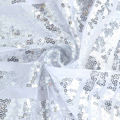 Silver sequin fabric with a sheer white background.