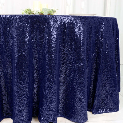 Navy sequin tablecloth draping over a table for elegant events.