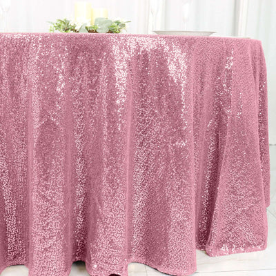 Pink sequin tablecloth draped over a table for elegant decor.