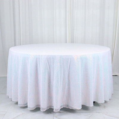 Round white tablecloth with iridescent sparkles, draped elegantly.