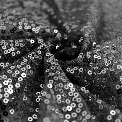 Black sequin fabric with shimmering texture and intricate details.