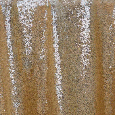 Gold sequin fabric with shimmering texture and patterns.