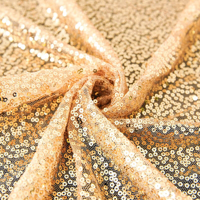 Gold sequin fabric with a shimmering texture perfect for crafts and fashion.