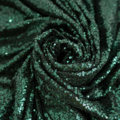 Green sequin fabric with a shiny, textured surface.