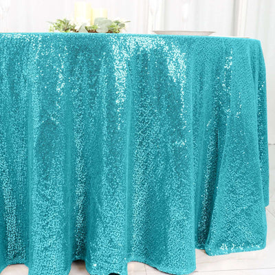 Teal sequin tablecloth draping elegantly over a table.