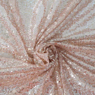 Rose gold sequin fabric with a shimmering, textured surface. #whtbkgd
