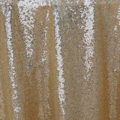 Gold sequin fabric with shimmering texture and intricate details.