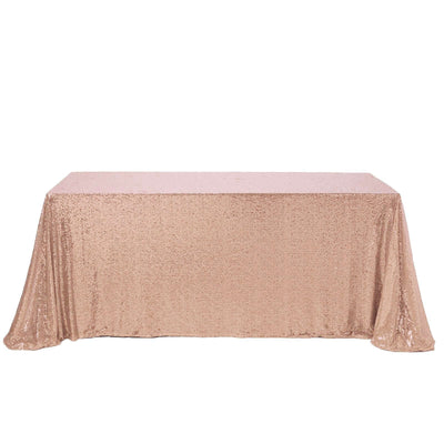 Rose gold sequin tablecloth on a plain background