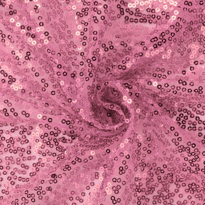 Pink sequin fabric with a shimmering texture.