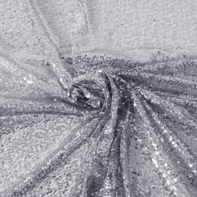 Silver sequin fabric draped elegantly, showcasing its shimmering texture.
