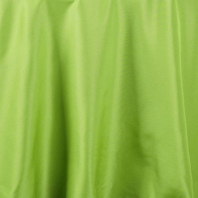 Vibrant green fabric draped elegantly, showcasing smooth texture.