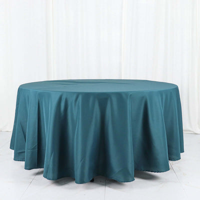 Teal round tablecloth on a white backdrop