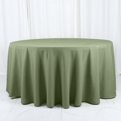 Round olive green tablecloth on a white backdrop