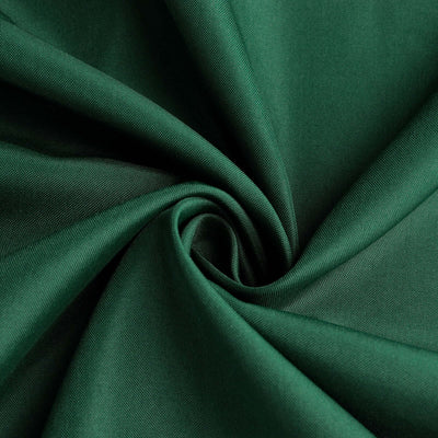 Green fabric swirl showcasing smooth texture and rich color.