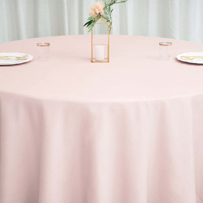 Pink round tablecloth draping elegantly over a table in a styled setting.