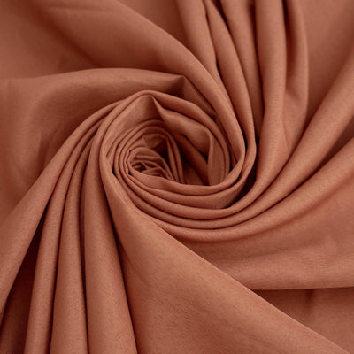 Rust-colored fabric in a swirling pattern.