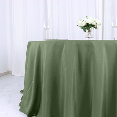 Olive green tablecloth draped elegantly on a dining table with floral centerpiece.