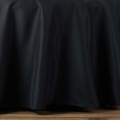 Black tablecloth draping elegantly over a wooden surface.