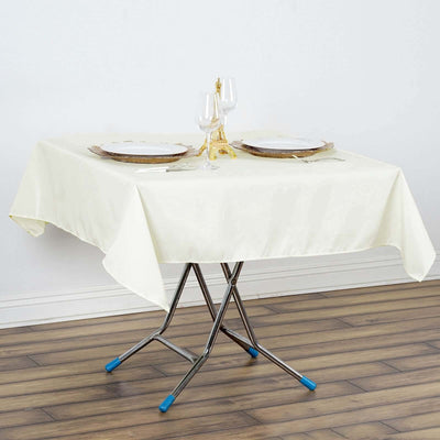 Elegant cream tablecloth draped over a folding table set for dinner.