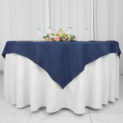 Navy tablecloth draped elegantly over a round table with floral decorations.