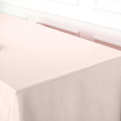 Pink tablecloth draping over a table in a softly lit room.