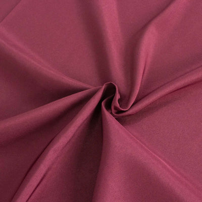 Burgundy fabric texture with smooth, flowing drape.