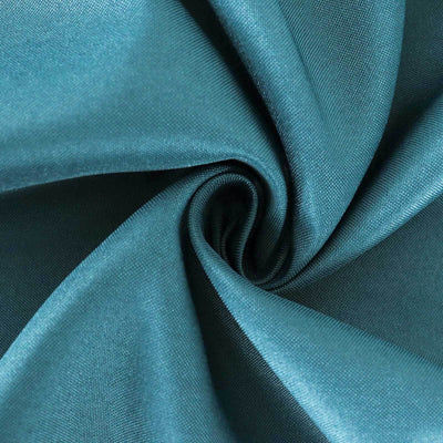 Teal fabric with smooth texture, elegantly twisted in a spiral pattern.