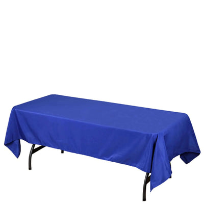 Blue tablecloth on a folding table against a plain background