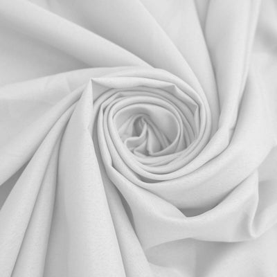 White fabric rolled in a spiral pattern.