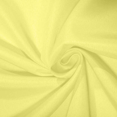 Light yellow fabric texture in a swirling pattern.