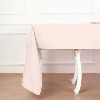 Pink tablecloth draped over a table in a minimalist setting.