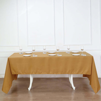 Elegant gold tablecloth draped over a dining table set for a meal.