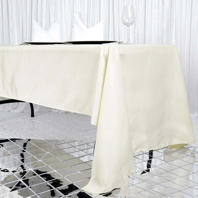 Elegant ivory tablecloth draping over a modern table setup.