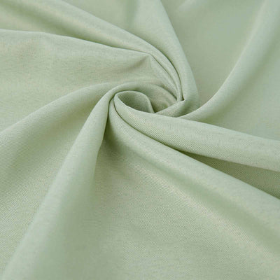 Light green fabric with a smooth texture, softly arranged in a spiral.