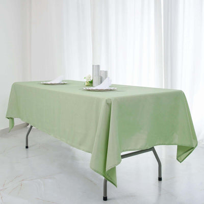 Green tablecloth draped over a folding table in a bright, airy setting.