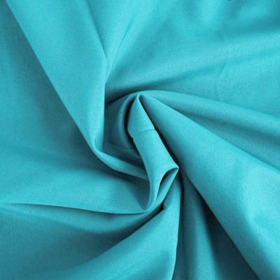 Turquoise fabric with a smooth texture, ideal for sewing and crafting.
