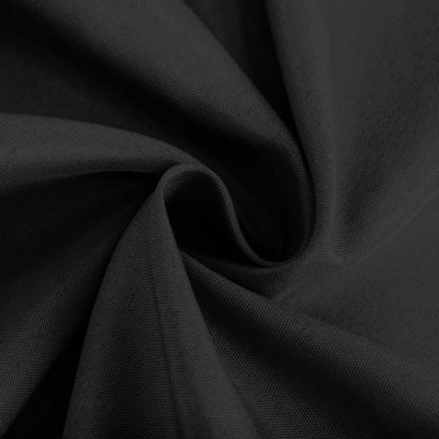 Black textured fabric close-up displaying soft draping and detailed weave.
