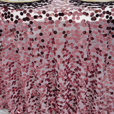 Pink sequin tablecloth with shiny round embellishments.