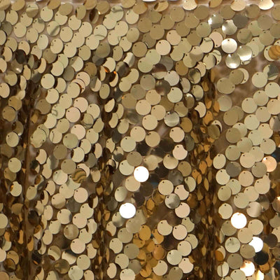 Shiny gold sequin fabric texture for fashion and decor.