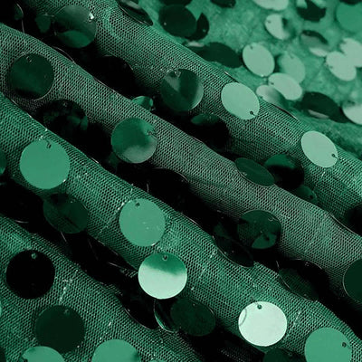 Green sequin fabric with shimmering circular sequins.