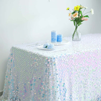Table covered with iridescent sequin tablecloth and floral centerpiece.