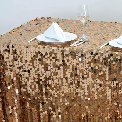 Sparkling rose gold sequin tablecloth with elegant table setting.