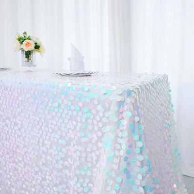 Iridescent sequin tablecloth draped over a table in a bright setting.