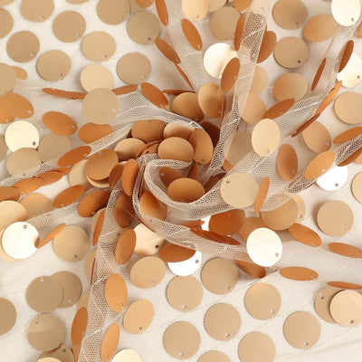 Gold sequin fabric with circular sequins on a sheer background.