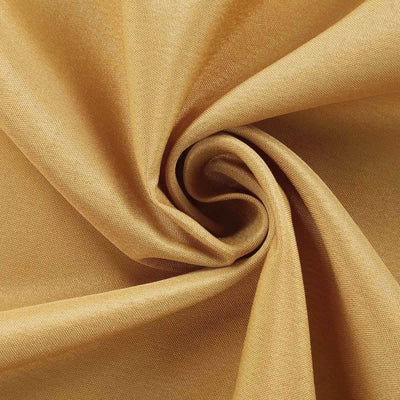 Golden fabric swirl showcasing texture and sheen.