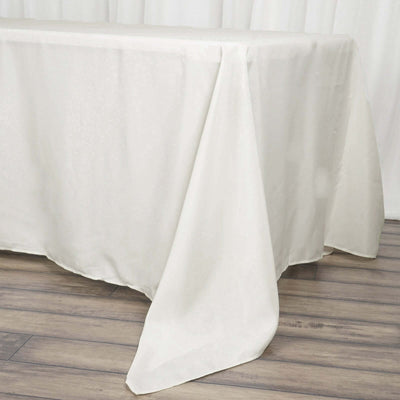 White tablecloth draping elegantly over a wooden table.