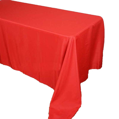 Red tablecloth draping over a table in a studio-style isolation shot